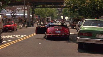 Movie still from “Anything Else” (2003), directed by Woody Allen – A red car parked on the side of the road; Wide shot, High angle
