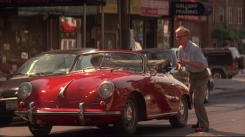 Movie still from “Anything Else” (2003), directed by Woody Allen – A man is standing in front of a red car; Wide shot, Over the shoulder angle