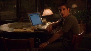 Movie still from “Anything Else” (2003), directed by Woody Allen – A man sitting in front of an open laptop computer; Medium shot, High angle