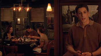 Movie still from “Anything Else” (2003), directed by Woody Allen – A group of people sitting at a table in a restaurant; Medium shot, Over the shoulder angle