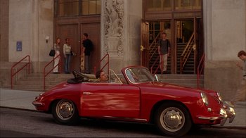 Movie still from “Anything Else” (2003), directed by Woody Allen – A man in a red car driving down a street; Wide shot, High angle