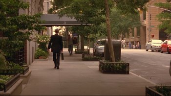 Movie still from “Anything Else” (2003), directed by Woody Allen – A woman walking down a sidewalk near a tree; Wide shot, Over the shoulder angle