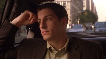 Movie still from “Anything Else” (2003), directed by Woody Allen – A man in a suit sitting in the back of a car; Close Up shot, High angle