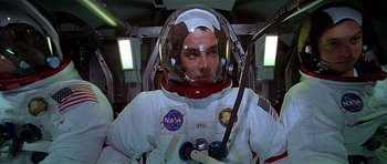 Movie still from “Apollo 13” (1995), directed by Ron Howard – A man in a spacesuit and helmet in a cockpit of an airplane; Medium shot, Low angle