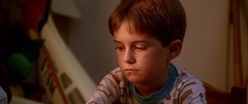 Movie still from “Apollo 13” (1995), directed by Ron Howard – A young boy sitting in front of a window; Close Up shot, Low angle