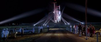 Movie still from “Apollo 13” (1995), directed by Ron Howard – A group of people standing on the side of a road; Extreme Wide shot, Low angle