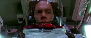 Movie still from “Apollo 13” (1995), directed by Ron Howard – A man wearing a space suit and a helmet; Close Up shot, Low angle
