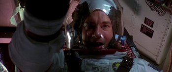 Movie still from “Apollo 13” (1995), directed by Ron Howard – A man wearing a space suit in a helmet; Close Up shot, Overhead angle