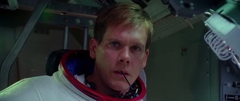 Movie still from “Apollo 13” (1995), directed by Ron Howard – A person wearing a space suit; Close Up shot, Low angle