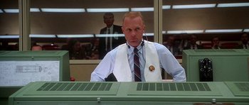 Movie still from “Apollo 13” (1995), directed by Ron Howard – A man in a white vest and a tie; Medium shot, Low angle