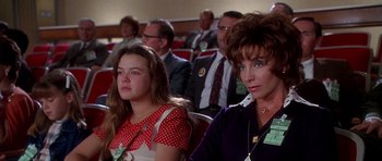 Movie still from “Apollo 13” (1995), directed by Ron Howard – A group of people sitting next to each other in a room; Medium shot, High angle