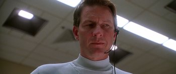 Movie still from “Apollo 13” (1995), directed by Ron Howard – A man with a headset on looking at the camera; Close Up shot, Low angle