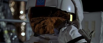 Movie still from “Apollo 13” (1995), directed by Ron Howard – A view of the inside of an airplane with the reflection of a cat in the mirror; Close Up shot, Overhead angle