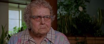 Movie still from “Apollo 13” (1995), directed by Ron Howard – An old woman with glasses is looking at the camera; Close Up shot, Over the shoulder angle
