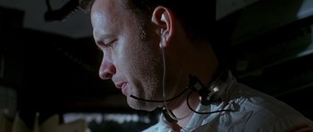 Movie still from “Apollo 13” (1995), directed by Ron Howard – A person wearing a headset; Close Up shot, Low angle