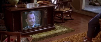 Movie still from “Apollo 13” (1995), directed by Ron Howard – An old tv sitting on top of a wooden table in a living room; Extreme Close Up shot, High angle