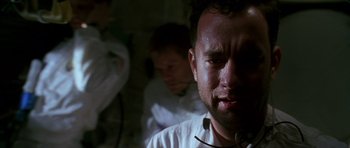 Movie still from “Apollo 13” (1995), directed by Ron Howard – A man in a white shirt is looking at the camera; Close Up shot, Low angle