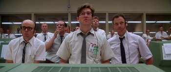 Movie still from “Apollo 13” (1995), directed by Ron Howard – A group of people in a room watching something; Medium shot, Low angle