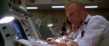 Movie still from “Apollo 13” (1995), directed by Ron Howard – A man sitting in front of a laptop computer; Close Up shot, Low angle