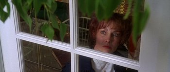 Movie still from “Apollo 13” (1995), directed by Ron Howard – A woman looking out of a window at a tree; Close Up shot, Over the shoulder angle