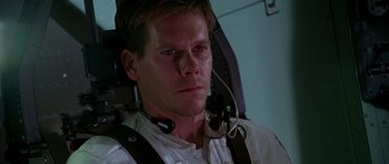 Movie still from “Apollo 13” (1995), directed by Ron Howard – A person wearing a headset; Close Up shot, Low angle