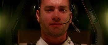 Movie still from “Apollo 13” (1995), directed by Ron Howard – A person wearing a headset; Close Up shot, Overhead angle