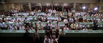 Movie still from “Apollo 13” (1995), directed by Ron Howard – A group of men sitting in front of each other in a room; Extreme Wide shot, High angle