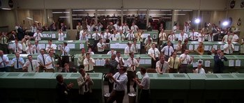 Movie still from “Apollo 13” (1995), directed by Ron Howard – A large group of people in a room; Extreme Wide shot, High angle