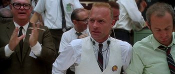Movie still from “Apollo 13” (1995), directed by Ron Howard – A man in a white vest and a tie; Close Up shot, Low angle
