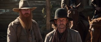 Movie still from “Appaloosa” (2008), directed by Ed Harris – A man with a beard wearing a hat and a scarf; Medium shot, Low angle