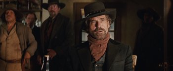 Movie still from “Appaloosa” (2008), directed by Ed Harris – A man in a cowboy hat and a scarf; Medium shot, Low angle