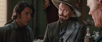 Movie still from “Appaloosa” (2008), directed by Ed Harris – A man with a long beard and a cowboy hat; Close Up shot, Over the shoulder angle