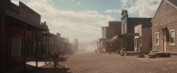Movie still from “Appaloosa” (2008), directed by Ed Harris – An old western town is deserted on a cloudy day; Extreme Wide shot, Low angle