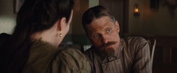 Movie still from “Appaloosa” (2008), directed by Ed Harris – A man sitting in front of a woman looking at him in the mirror; Close Up shot, Over the shoulder angle