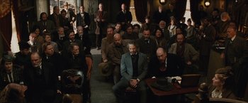 Movie still from “Appaloosa” (2008), directed by Ed Harris – A group of people sitting in a living room; Wide shot, High angle