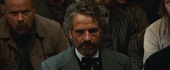 Movie still from “Appaloosa” (2008), directed by Ed Harris – A person wearing a suit and tie; Close Up shot, Over the shoulder angle