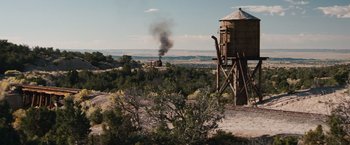 Movie still from “Appaloosa” (2008), directed by Ed Harris – An image of a steam train going down the tracks in the desert; Extreme Wide shot, High angle