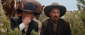 Movie still from “Appaloosa” (2008), directed by Ed Harris – A couple of men wearing cowboy hats next to each other; Close Up shot, Low angle