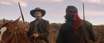 Movie still from “Appaloosa” (2008), directed by Ed Harris – A man and a woman are standing on a dirt hill; Medium shot, Over the shoulder angle