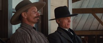 Movie still from “Appaloosa” (2008), directed by Ed Harris – A couple of men wearing hats and suits; Close Up shot, Low angle