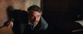 Movie still from “Appaloosa” (2008), directed by Ed Harris – A person wearing a suit and tie; Close Up shot, Over the shoulder angle