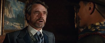 Movie still from “Appaloosa” (2008), directed by Ed Harris – A person wearing a suit and tie; Close Up shot, Over the shoulder angle