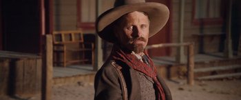 Movie still from “Appaloosa” (2008), directed by Ed Harris – A man with a long beard wearing a cowboy hat; Close Up shot, Low angle