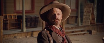 Movie still from “Appaloosa” (2008), directed by Ed Harris – A man with a long beard wearing a cowboy hat; Close Up shot, Low angle
