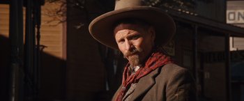 Movie still from “Appaloosa” (2008), directed by Ed Harris – A man with a long beard wearing a cowboy hat; Close Up shot, Low angle