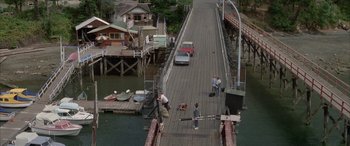 Movie still from “April Fool's Day” (1986), directed by Fred Walton – A couple of people standing on top of a wooden dock; Extreme Wide shot, High angle