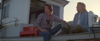 Movie still from “April Fool's Day” (1986), directed by Fred Walton – A man sitting on the back of a truck; Medium shot, Low angle