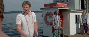 Movie still from “April Fool's Day” (1986), directed by Fred Walton – Two men standing next to each other on a boat; Medium shot, Low angle