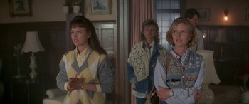 Movie still from “April Fool's Day” (1986), directed by Fred Walton – A group of women standing next to each other in a room; Medium shot, Over the shoulder angle