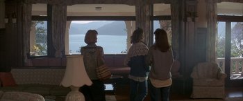 Movie still from “April Fool's Day” (1986), directed by Fred Walton – A group of people looking out of a window at the ocean; Wide shot, High angle